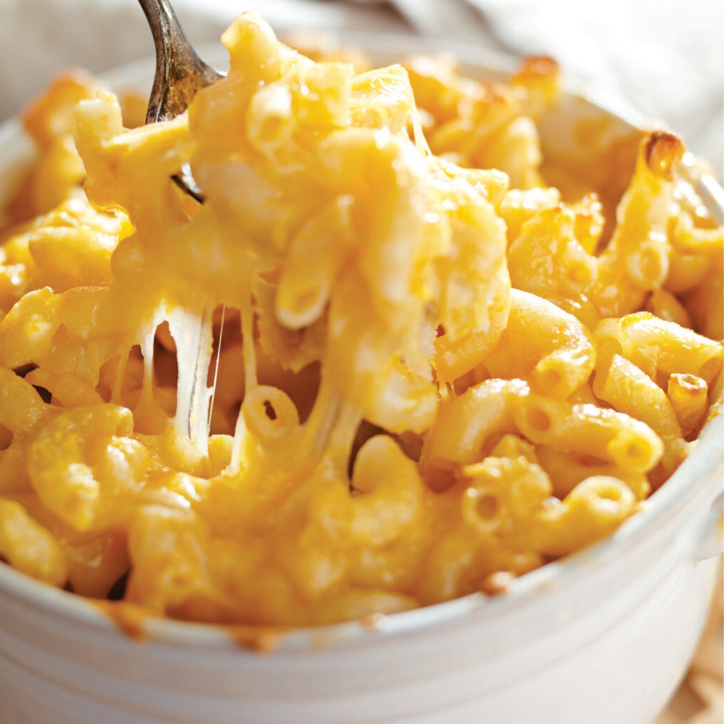 prepared frozen macaroni and cheese, heat-n-eat ready meal that can be prepared in the microwave, airfryer or oven. Each serving showcases perfectly cooked pasta smothered in our luxuriously creamy sauce that's bursting with rich, cheesy goodness. The pièce de résistance is the extra layer of premium melted cheese on top, adding a delightful gooey texture and an intensified cheese flavor to every bite.